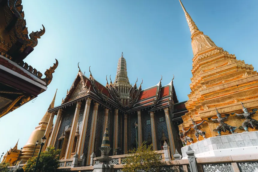 Beautiful capture of Grand Palace temple's intricate architecture and golden pagoda in Bangkok, Thailand.