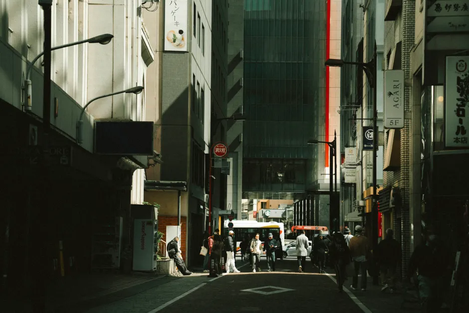View of a bustling street in Tokyo with pedestrians, showcasing urban architecture and city life.