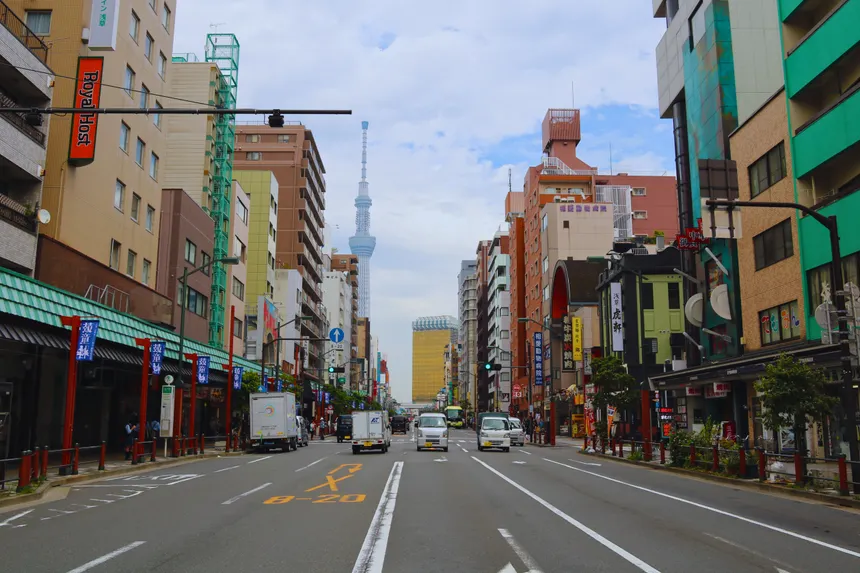 Vibrant street view in Tokyo with Skytree tower and bustling activity, capturing urban life.