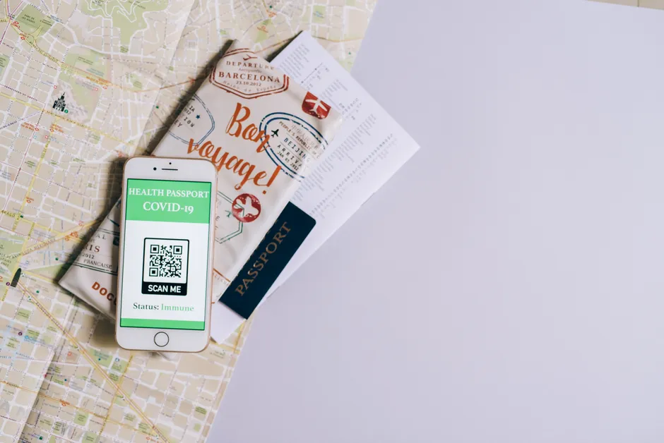 Smartphone displaying health passport with travel documents on a map, showcasing modern travel preparation.