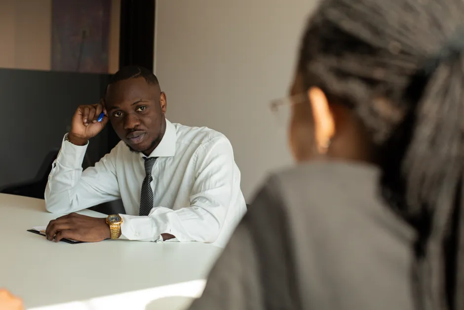 Two adults having a focused business discussion in a modern office environment.