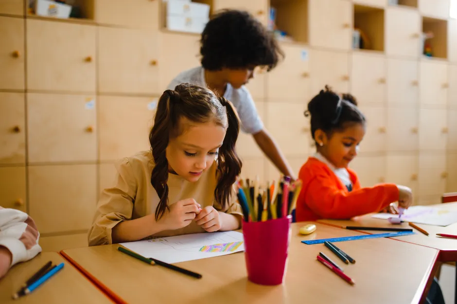 Children participating in creative activities in a bright classroom setting, emphasizing education and diversity.