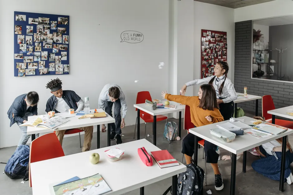 Students enjoying break time in a lively classroom setting.